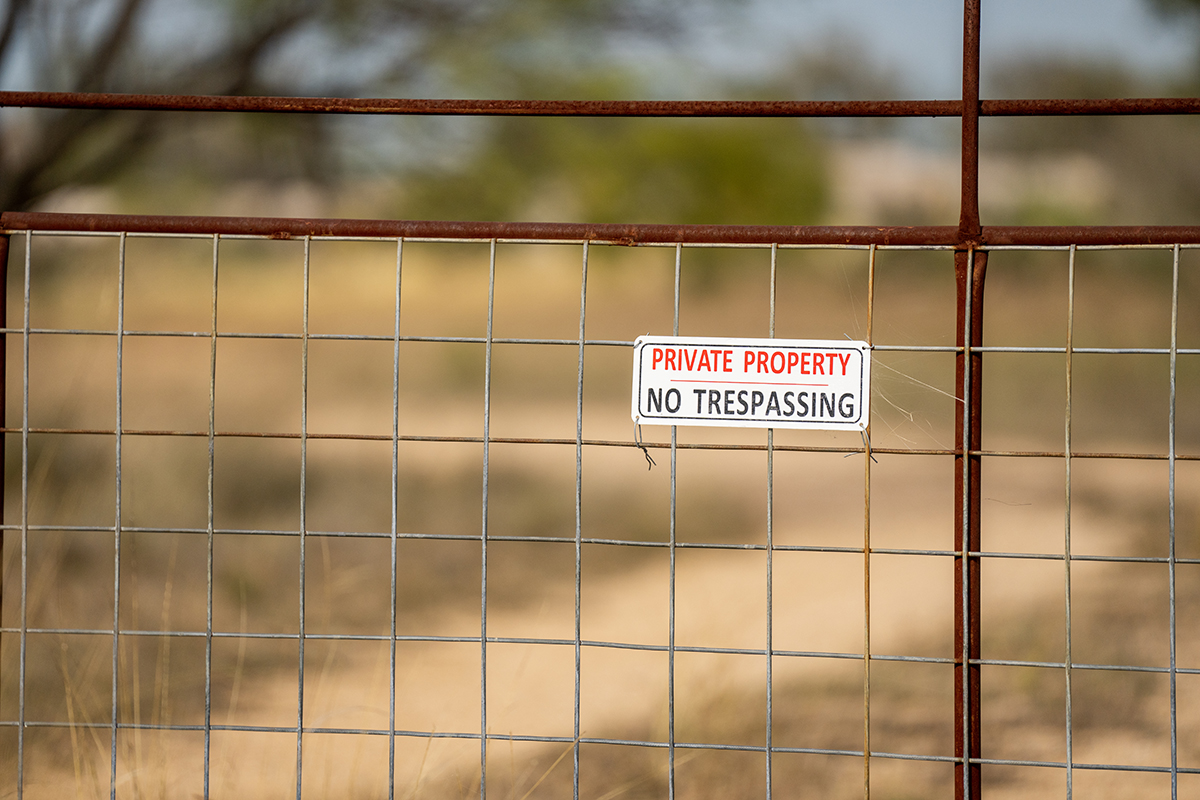 Private property signs cover a gate on some land in West Texas on Monday, Dec 05, 2022. (Sam Craft/Texas A&M AgriLife Marketing and Communications)