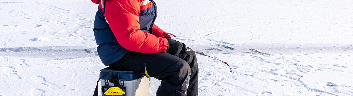 Boy enjoys winter fishing. (Adobe Stock │ #407385436 - Maksym Dragunov)