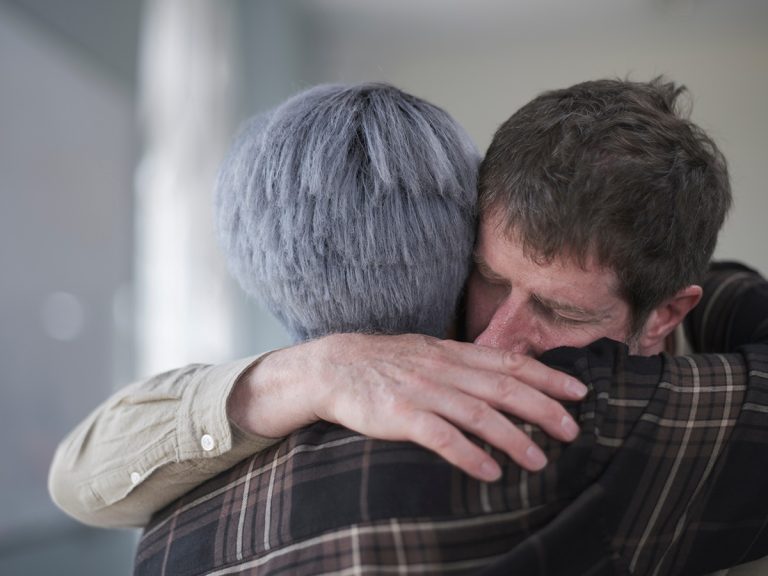 Man and woman hugging in therapy session. (Adobe Stock │ #520783324 - Cultura Creative)