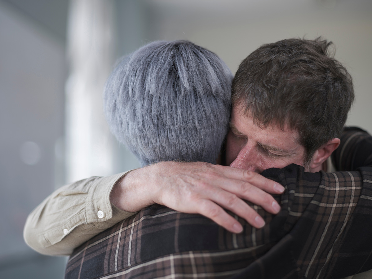 Man and woman hugging in therapy session. (Adobe Stock │ #520783324 - Cultura Creative)