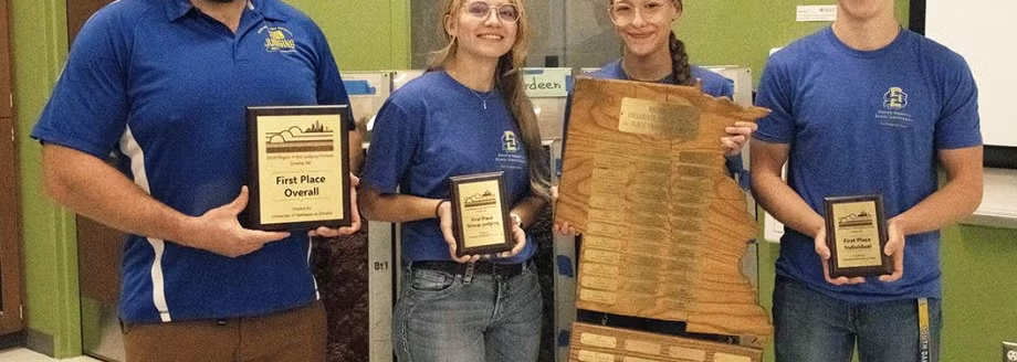 The SDSU Soil Judging Team brought home first-place honors from the National Collegiate Soil Judging Region 5 competition held recently in Omaha, Nebraska. Pictured from left are assistant professor of soils and pedology in the Department of Agronomy, Horticulture and Plant Science Kristopher Osterloh, with team members Harlee Nielson, Abigayle Eitreim and senior team leader Luke Desmith, who also won first place in the individual judging category. (South Dakota State University)