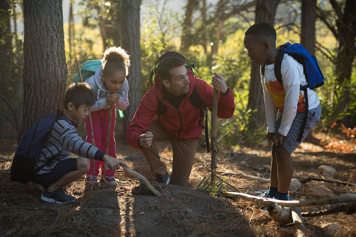 Teacher and kids examining soil. (Adobe Stock │ #181494152 - WavebreakMediaMicro)