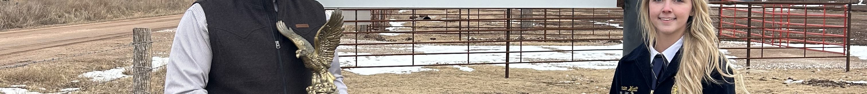 (Left) Kellen Allison pictured in front of his feedlot operation sign with his Oklahoma State Star Farmer Award, and Waynoka FFA Chapter Reporter Chanan Wyatt. (Courtesy photo.)