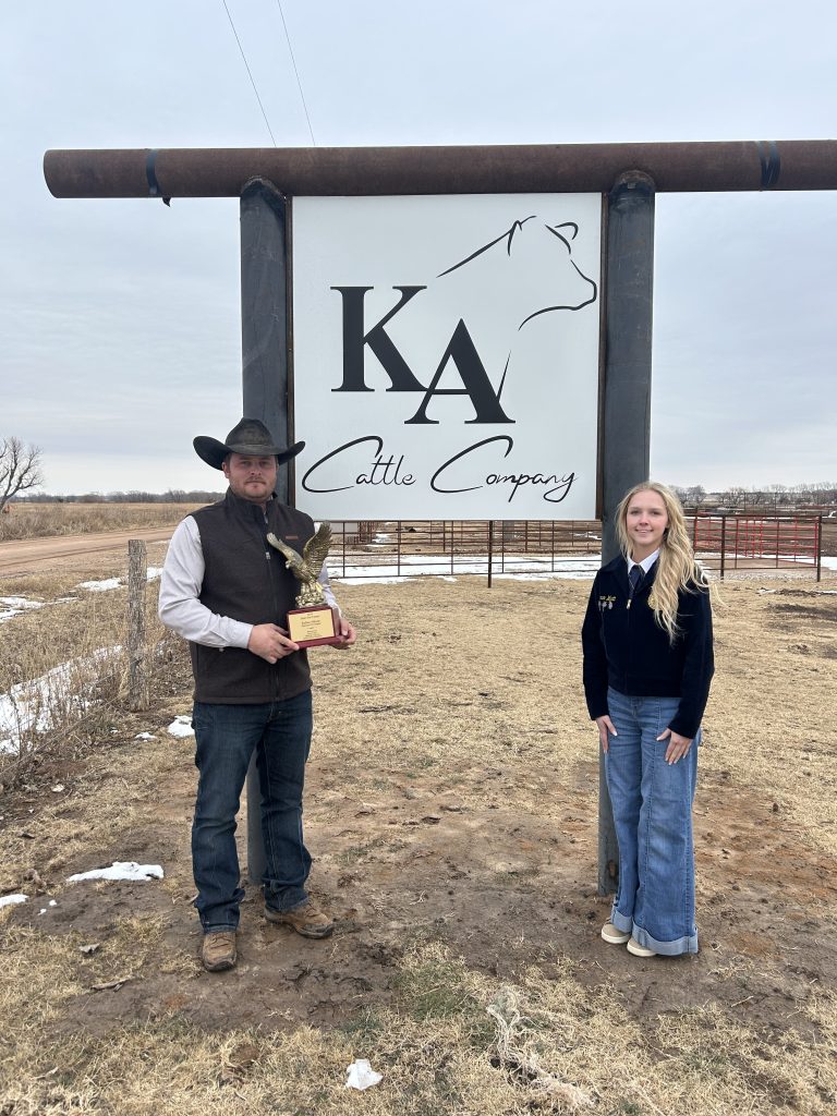 (Left) Kellen Allison pictured in front of his feedlot operation sign with his Oklahoma State Star Farmer Award, and Waynoka FFA Chapter Reporter Chanan Wyatt. (Courtesy photo.)