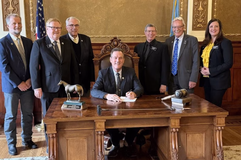 South Dakota State University officials and state lawmakers look on as South Dakota Gov. Larry Rhoden signs a bill Tuesday authorizing the expansion of the SDSU Swine Education and Research Facility. From left are Distinguished Professor and SDSU Extension Swine Specialist Bob Thaler, District 7 Rep. Tim Reed, SDSU President Barry Dunn, Rhoden, District 20 Rep. Paul Miskimins, District 13 Rep. Jack Kolbeck and District 7 Rep. Mellissa Heermann. (South Dakota State University)