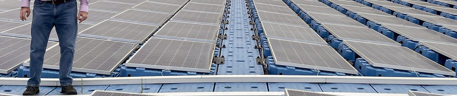 Michael Popp, Harold F. Ohlendorf Professor of agricultural economics and agribusiness for the University of Arkansas System Division of Agriculture and the Dale Bumpers College of Agricultural, Food and Life Sciences, stands on a floating solar array in Spain in 2024. (Photo courtesy of Mike Popp)