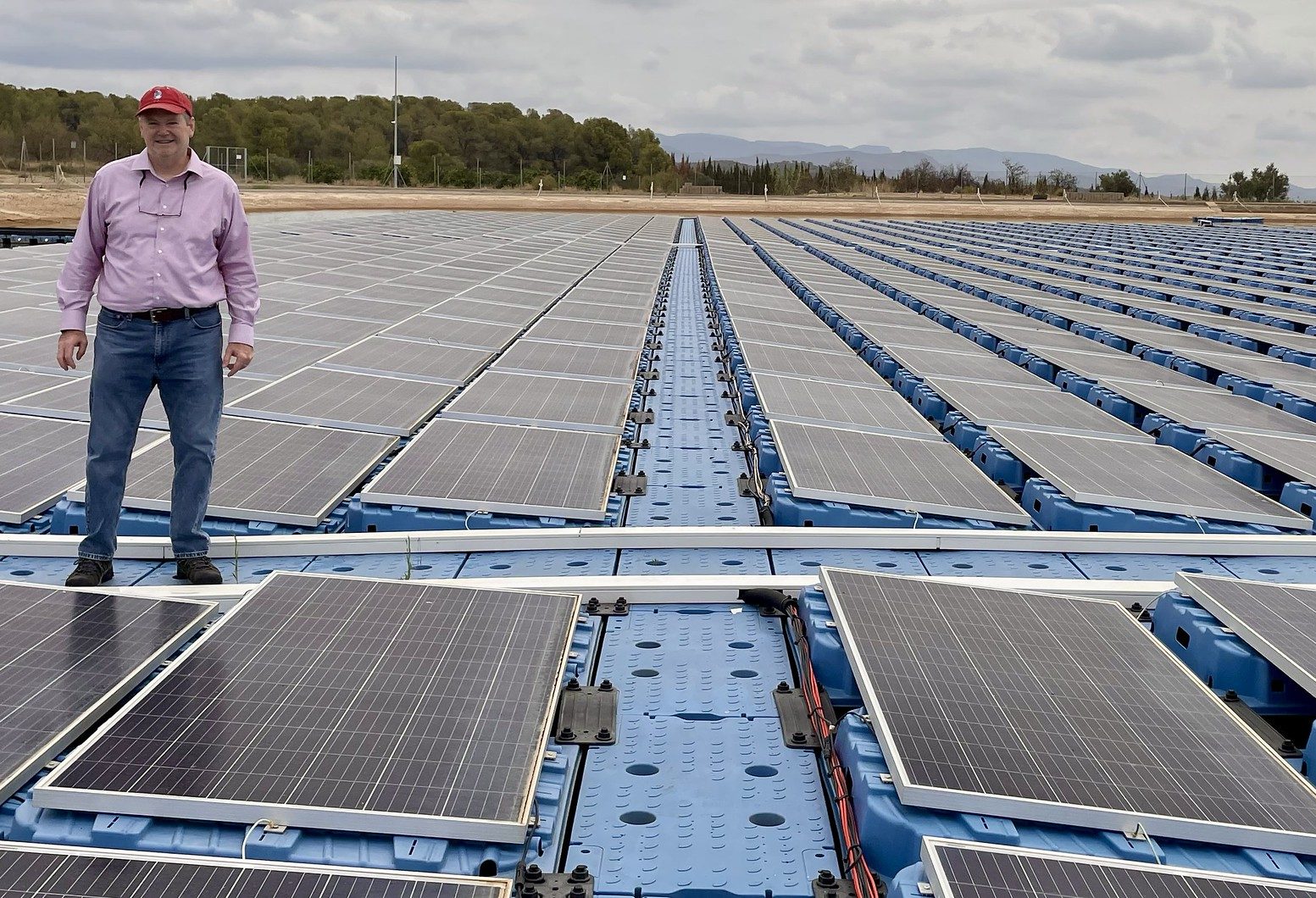 Michael Popp, Harold F. Ohlendorf Professor of agricultural economics and agribusiness for the University of Arkansas System Division of Agriculture and the Dale Bumpers College of Agricultural, Food and Life Sciences, stands on a floating solar array in Spain in 2024. (Photo courtesy of Mike Popp)