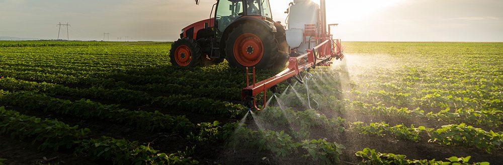 Tractor spraying soy field in sunset. (Adobe Stock-#355841291 │ Dusan Kostic)