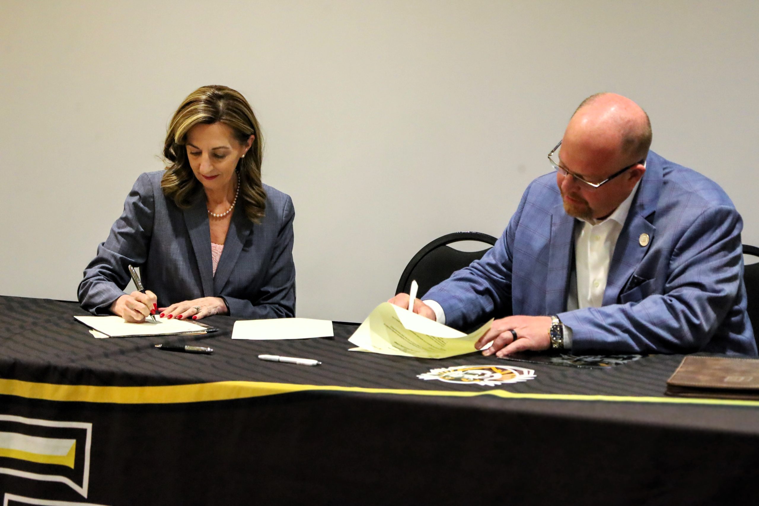 (Left) Tisa Mason and Ryan Ruda sign the agreement. (Courtesy photo.)