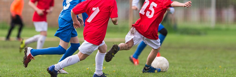 Boys kicking ball. (Adobe Stock-#110675056 │ Dusan Kostic)