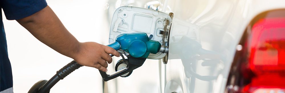 Refilling a white pickup truck with fuel at a gas station. (Adobe Stock-#247993817 │ Koonsiri)