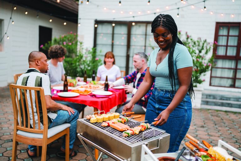 Cozy outdoor dining area set up for a rustic BBQ party. (Shutterstock-#2620008979 │ Chokniti-Studio)