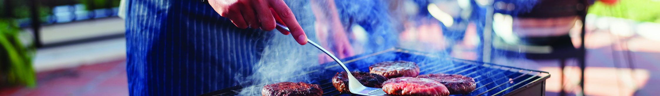 Photo courtesy of Shutterstock (Grilling hamburgers. Shutterstock │ #2475095419 - PeopleImages)