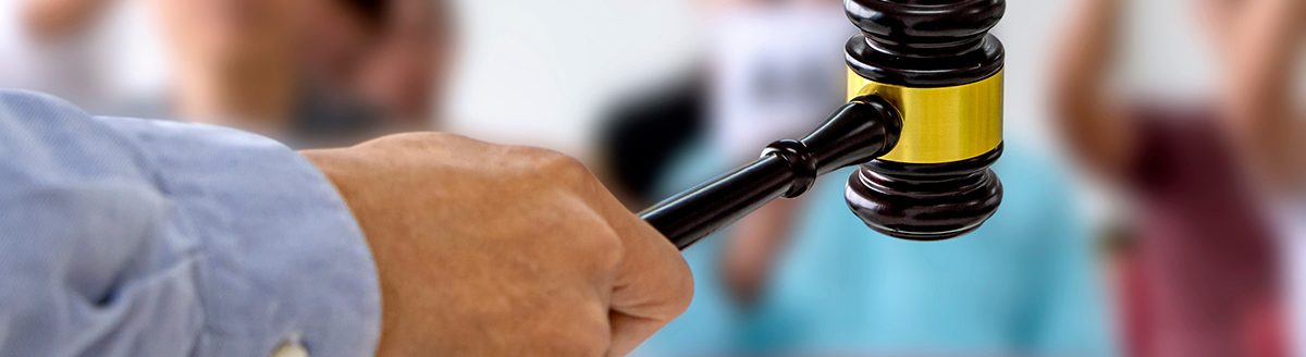 The person carrying the auction holds a wooden hammer in his hand to make a bid to sell the product. (Adobe Stock-#309197587 │ Pongsak)
