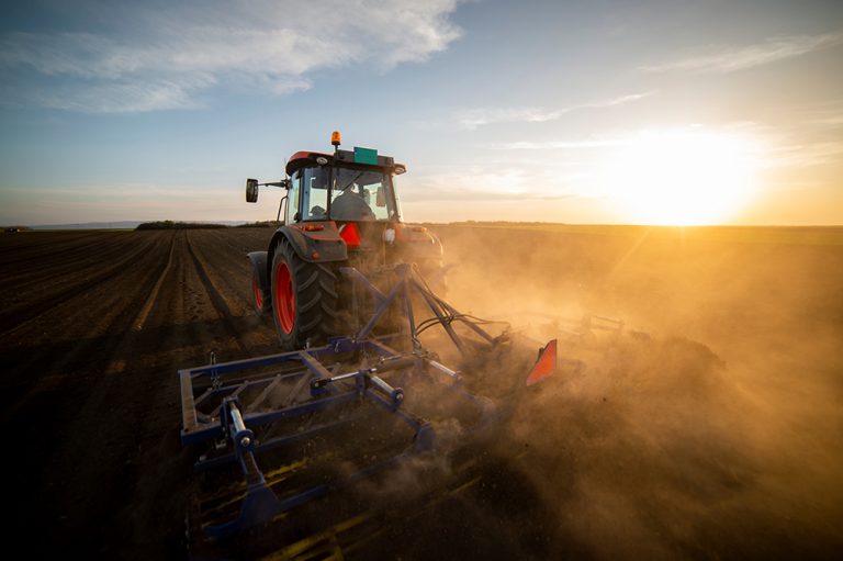 Tractor working in the field. (Adobe Stock-#500442427 │ Vesna)