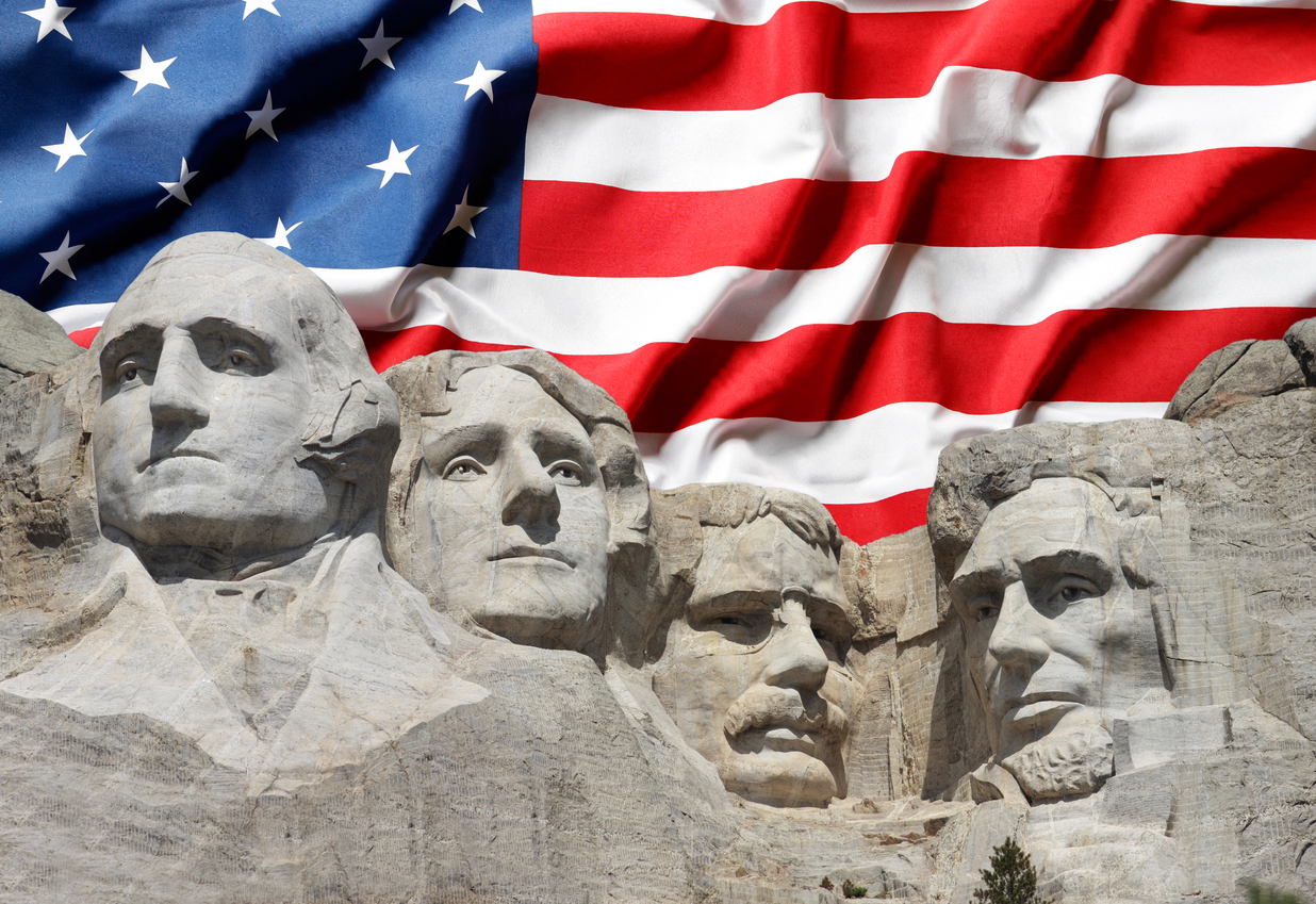 Mount Rushmore with American Flag Background. (iStock-#180975365 │ FrozenShutter)