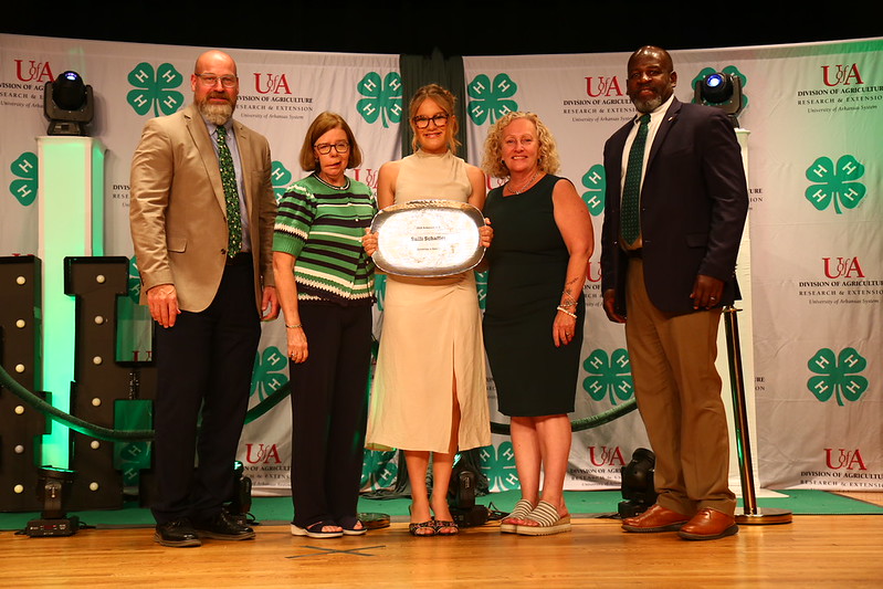 A CUT ABOVE — Sulli Schaffer, center, accepts the 2026 Arkansas 4-H Governor's Award at the State O-Rama Awards of Excellence ceremony in Fayetteville, Ark. (Division of Agriculture image.)