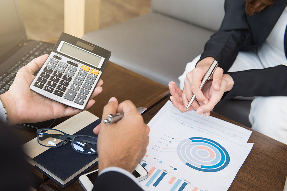 Business people calculating and discussing financial documents. (Adobe Stock-#126893597 │ Atstock Productions)