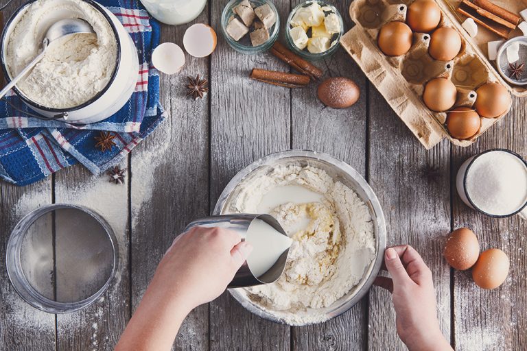 Making dough top view on rustic wood background. (Adobe Stock-#172159140 │ Prostock-studio)