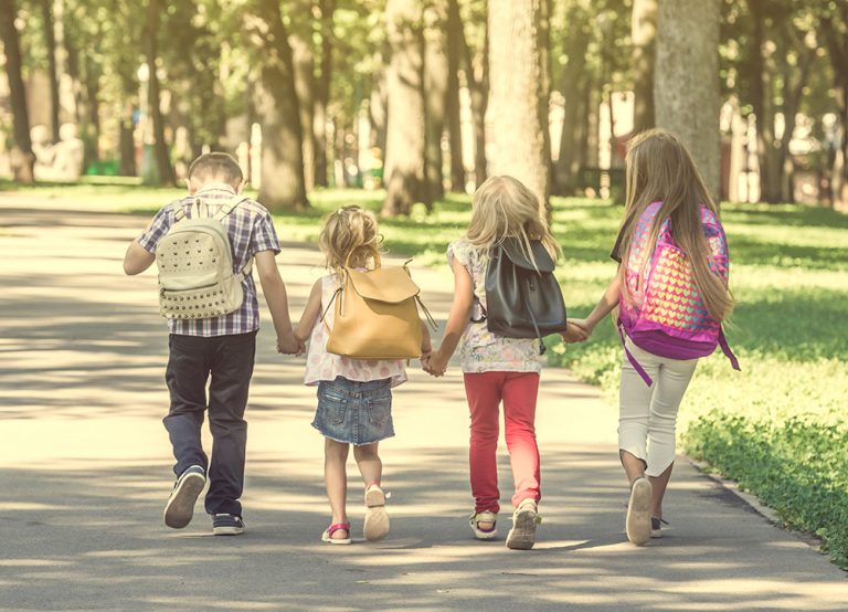Little pupils walking home from school. (Adobe Stock-#231235700 │ tan4ikk)