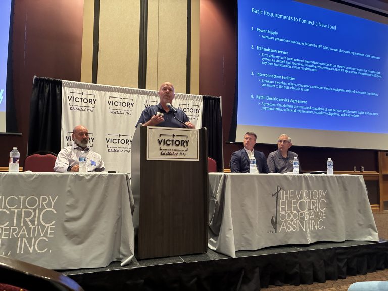 (At podium) Corey LInville speaks at a July 21 community frorum as (left) Shane Laws, Michael Burns, Nick Hernandez, and (not pictured) Gary Thomas listen. (Journal photo by Dave Bergmeier.)