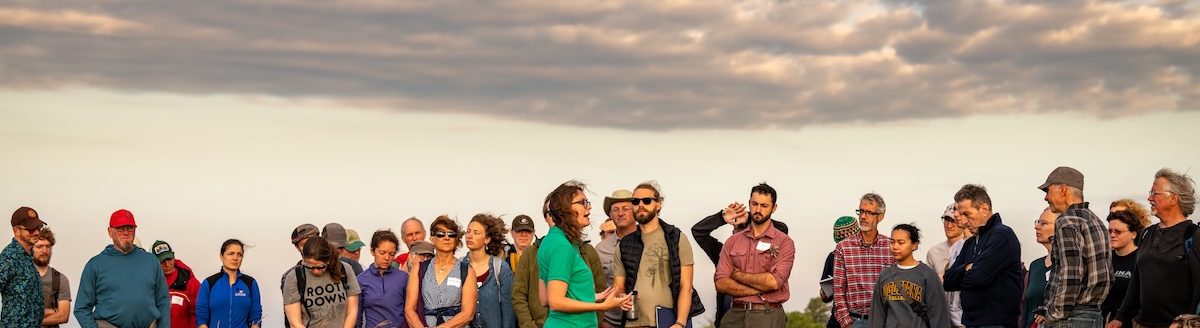 Aubrey Streit Krug, The Land Institute's director of Ecospheric Studies, talks of the prairie as she leads a sunrise prairie walk that is part of the institute's annual Prairie Festival. (Courtesy photo)