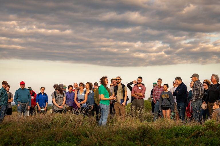 Aubrey Streit Krug, The Land Institute's director of Ecospheric Studies, talks of the prairie as she leads a sunrise prairie walk that is part of the institute's annual Prairie Festival. (Courtesy photo)