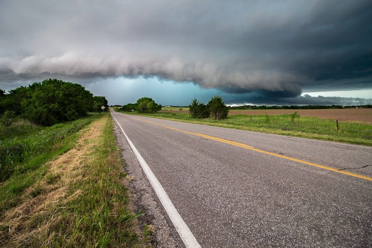 A shelf cloud and severe storm filled with rain and hail approach a highway in Kansas. (Adobe Stock-#515547088 │ Dan Ross)