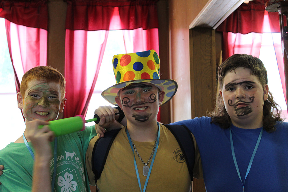 4-H Clown College participants pose for photo with face paint. (University of Missouri Extension 4-H)