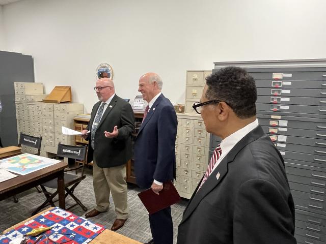 BLM Director Stevan Pearce (middle), BLM Eastern State Director Mitchell (right) Leverette and acting Associate State Director Dave Radford (left) listen as a presenter discusses historic land title records during a rare tour of the General Land Office vault, offered after the July 15 ribbon cutting ceremony recognizing updates to the GLO website and expanded digital access. (BLM Courtsey photo)